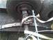 1989 Ford Bronco - Close-up view of a trailer axle assembly, showing suspension components and tires.