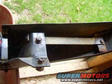 Black metal bumper bracket with bolts and support beam, Supermotors logo visible