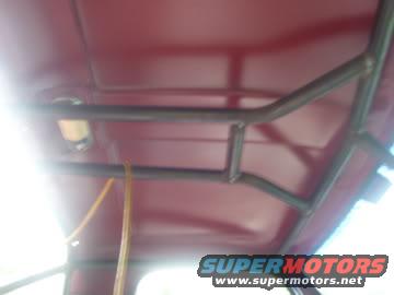 Interior view of a metal roll cage structure mounted to the roof of a vehicle