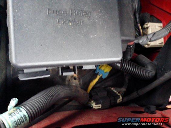Fuse relay center with visible wiring and a green tag labeled '3009'