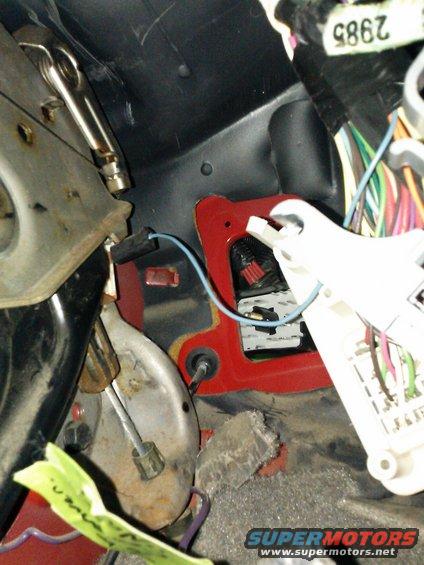 Interior view of wiring and red bracket with white connector