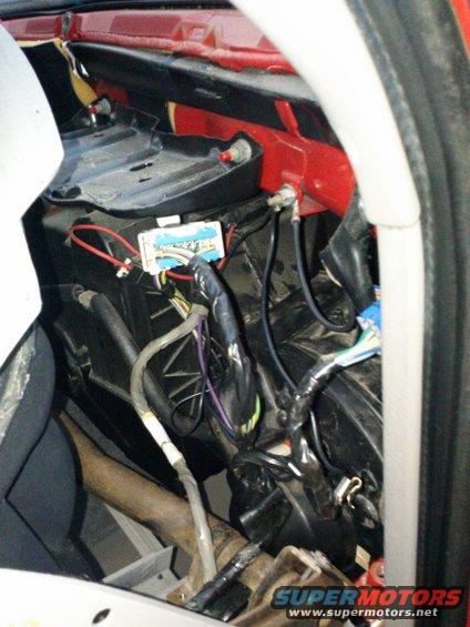 Close-up of a vehicle's interior wiring harness and HVAC components