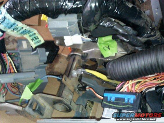 Vehicle interior wiring harness with green and blue connectors and black tubing