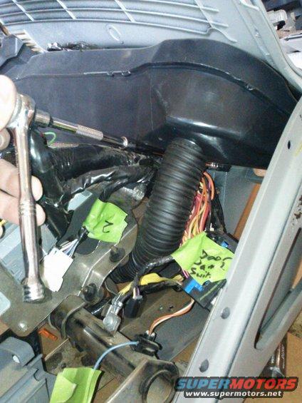 Interior dashboard wiring with green tape labels and a ratchet