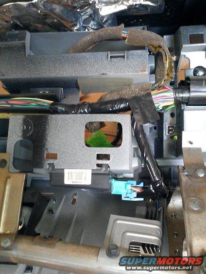 Close-up of vehicle dashboard wiring harness and electronic modules