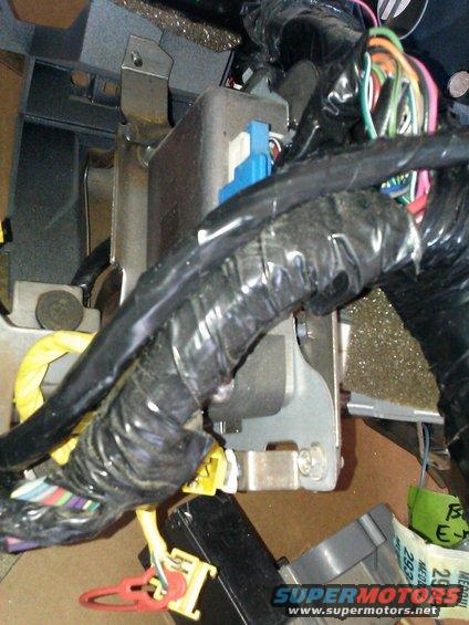Vehicle interior wiring harness with black tape, yellow and blue connectors, and multicolored wires