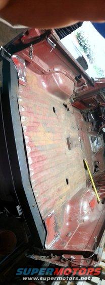 Photo of a red bare cab floor pan during vehicle restoration
