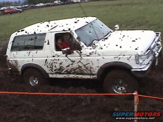 White 1989 Ford Bronco in mud