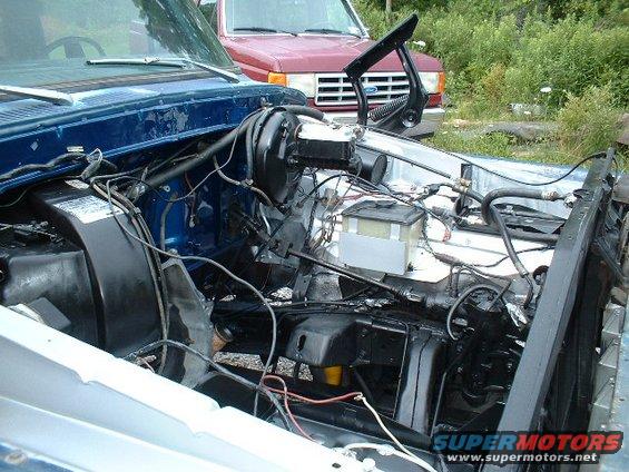 Blue 1978 Ford F-250 engine bay with brake booster and master cylinder visible
