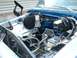 1978 Ford F-250 - The engine bay of a vehicle, showing various mechanical parts and blue painted surfaces.