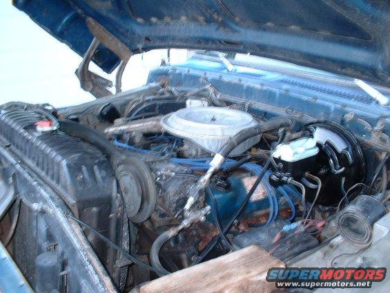 Blue 1978 Ford F-250 engine bay with hood open, showing the V8 engine, radiator, and brake booster