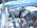 1978 Ford F-250 - Engine bay of a 1978 Ford F-250, the battery and air cleaner assembly.