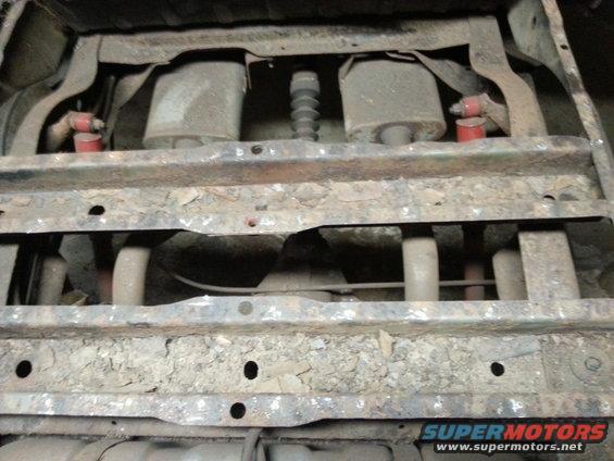 Undercarriage showing dual exhaust pipes and suspension. Supermotors.net logo visible