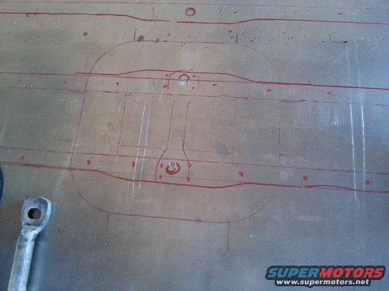 Metal plate with red marker lines and circles, possibly a template or diagram