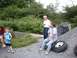 1978 Ford F-250 - A group of people are gathered outdoors near a pile of gravel and some tires.