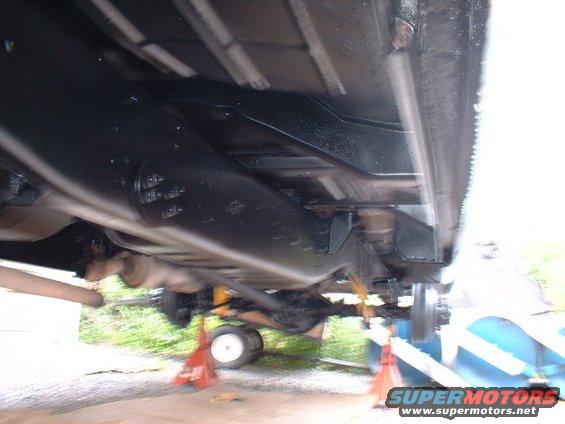 Underside of a 1978 Ford F-250 on jack stands, showing the frame and suspension components