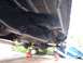 1978 Ford F-250 - The underside of a 1978 Ford F-250 is visible, supported by jack stands for maintenance.