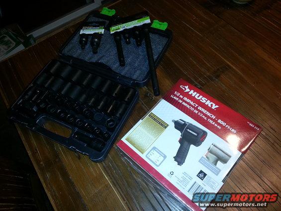 Socket set and Husky 1/2 in. impact wrench on wooden table