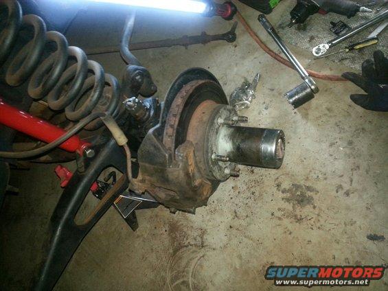 1984 Ford Bronco front suspension and brake assembly, showing a large coil spring and brake rotor
