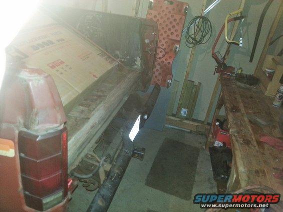 Tailgate and cargo area of a red SUV, possibly from the early 80s. Boxes are loaded in the back
