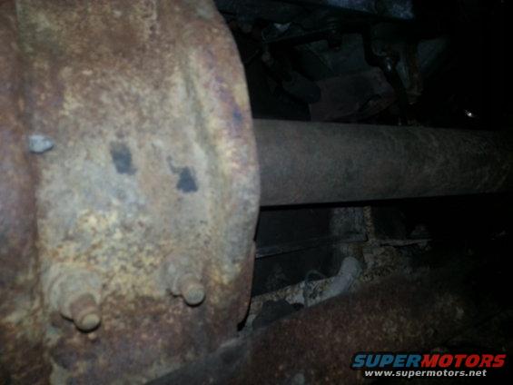 Close-up of rusty undercarriage part and exhaust pipe