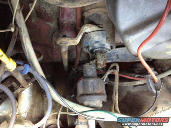 Close-up of engine parts, including distributor and wiring