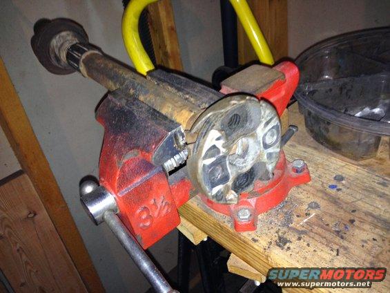 Part held in a red 3 1/2 inch vise on a workbench