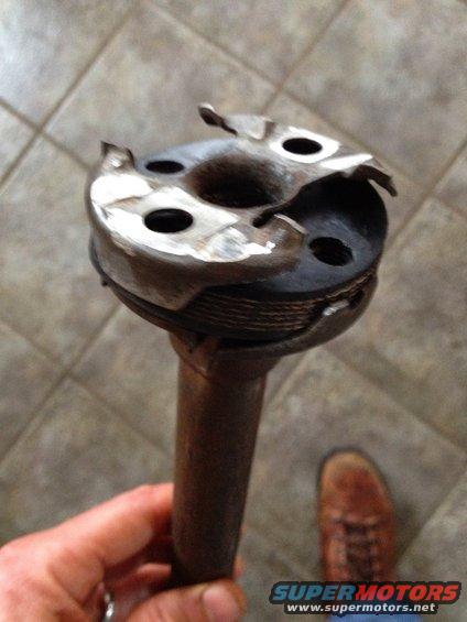 Hand holding a worn distributor cap and rotor assembly