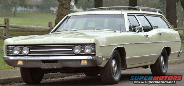 light green station wagon with roof rack, parked on a road