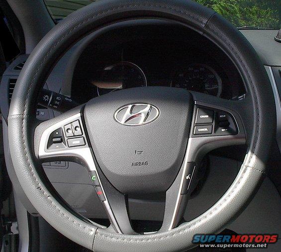 Hyundai steering wheel with airbag and cruise control buttons. Has a leather cover