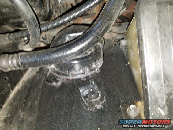 Close-up of hoses and parts in a vehicle's engine bay