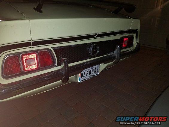 1971 Ford Mustang rear view, light yellow with black stripes and spoiler