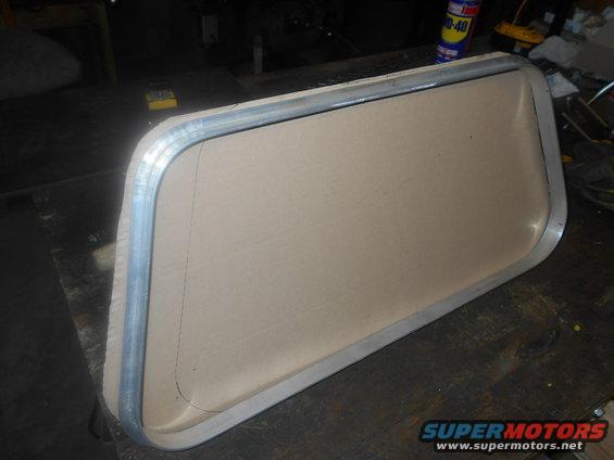 RV window frame with tan insert on a workbench