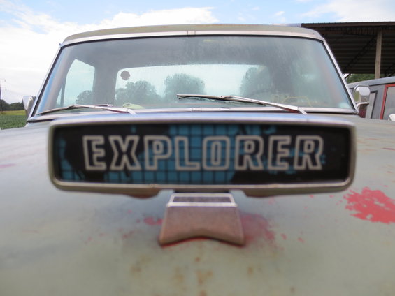 Light green truck with 'EXPLORER' emblem on the hood