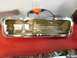 1967 Mercury Cougar - A chrome oil pan with visible internal structure is presented against a red background.