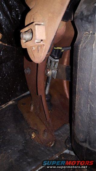 Interior view of a rusty pedal assembly with wiring