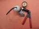 1967 Mercury Cougar - A vacuum gauge and pump assembly is shown with a red-handled tool attached.