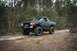 1989 Ford Bronco - This lifted 1989 Ford Bronco, equipped with a snorkel, navigates a wooded dirt path.