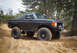 1989 Ford Bronco - This modified Ford Bronco navigates a sandy terrain, its off-road capabilities.
