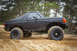 1989 Ford Bronco - This lifted Ford Bronco navigates a sandy terrain, its off-road capabilities.