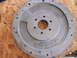 1963 Ford Galaxie - A metal Ford flywheel with a toothed outer edge and multiple bolt holes is shown.