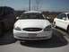 1999 Ford Taurus - Front view of a white Ford Taurus, showing its grille, headlights, and license plate.