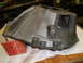 1963 Ford Galaxie - Cast iron part and an Autolite box are on a workbench.