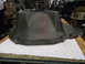 1963 Ford Galaxie - A large, dark gray, cast iron component sits on a workbench, possibly a transmission bell housing.