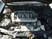 1999 Ford Taurus - The engine bay of a vehicle is shown with the hood open, revealing the V6 engine and surrounding components.