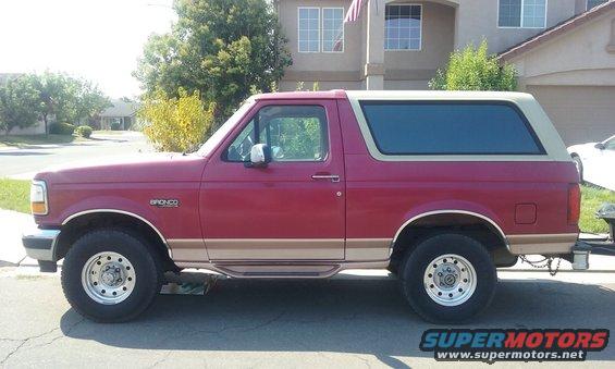 1995 Ford Bronco side profile, red body with tan trim and removable top