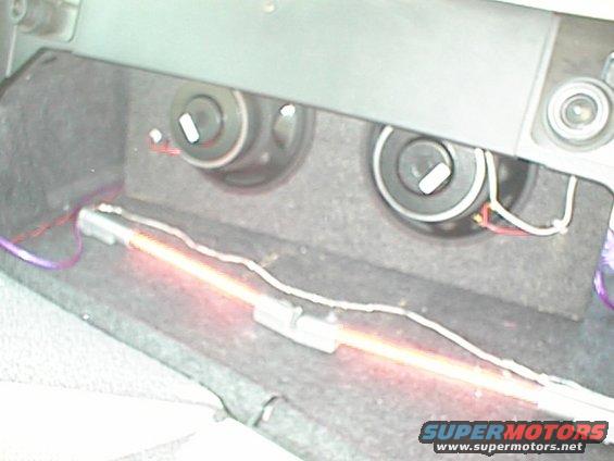 Car trunk interior showing two speakers and a neon light strip