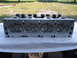 1963 Ford Galaxie - An aluminum engine cylinder head is displayed, showing its valves and springs.