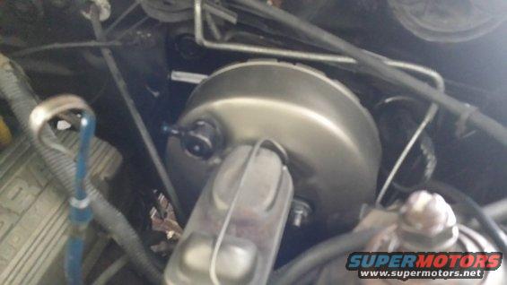 Brake booster and master cylinder assembly in engine bay