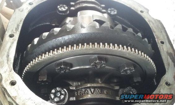 Close-up of differential gears inside a housing, with visible bolts and teeth